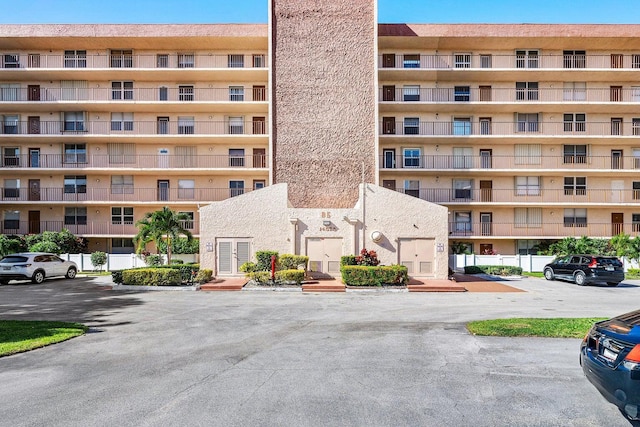 view of building exterior with uncovered parking