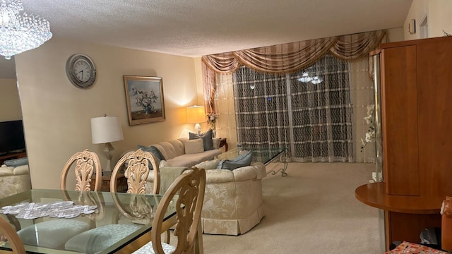 living room with an inviting chandelier, a textured ceiling, and carpet