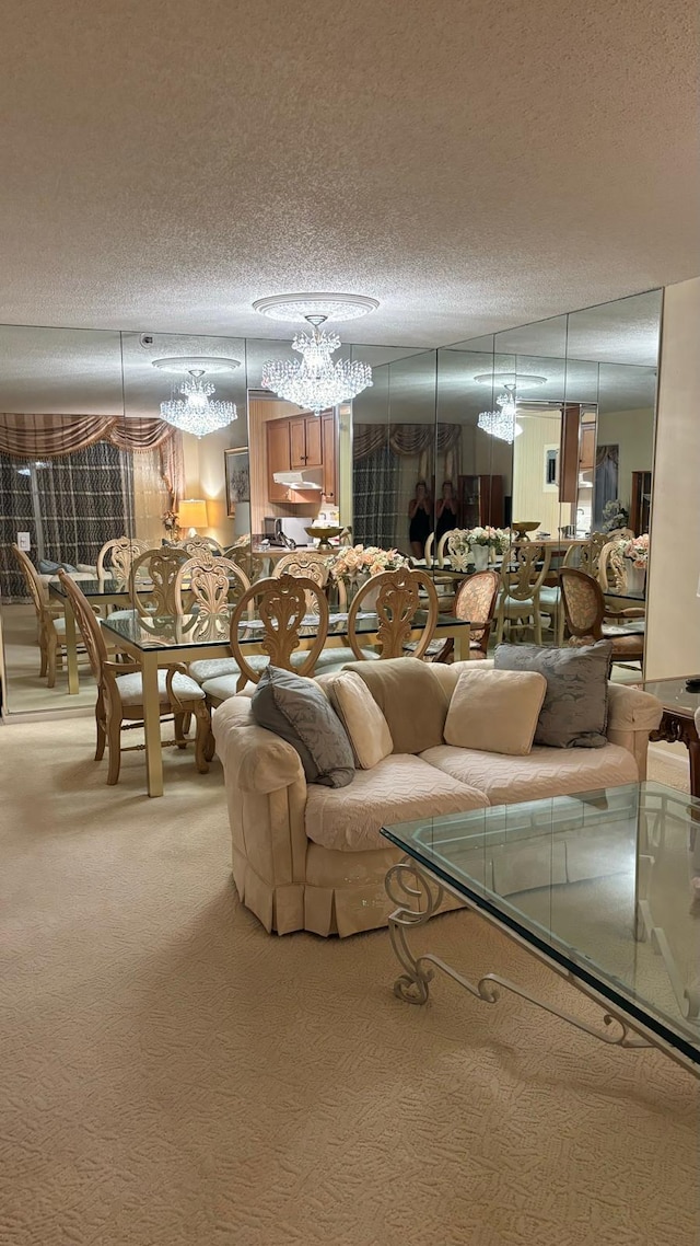 living room featuring a chandelier, a textured ceiling, and carpet floors