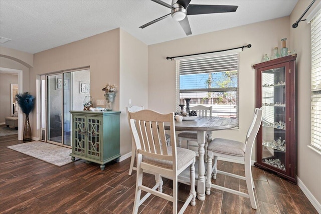 dining space featuring ceiling fan, a healthy amount of sunlight, and a textured ceiling