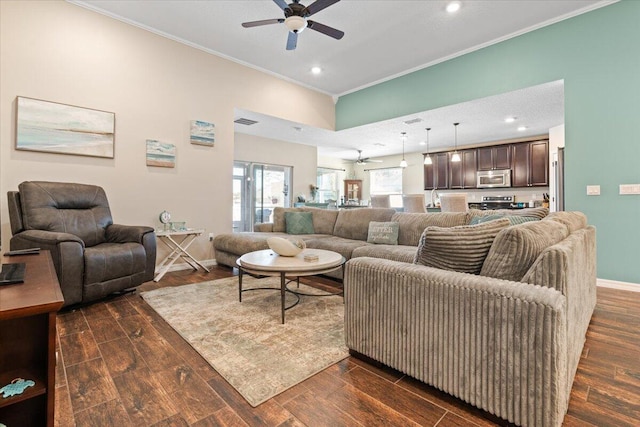 living room with crown molding and ceiling fan