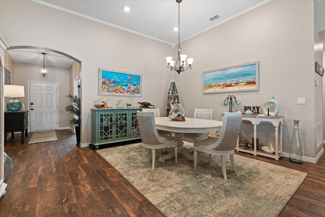 dining area with crown molding, dark hardwood / wood-style flooring, and a chandelier