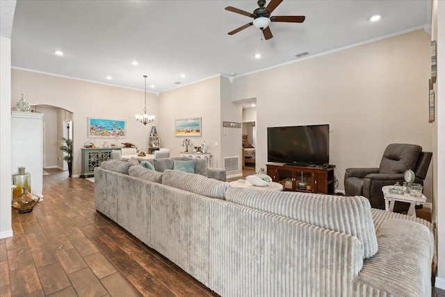 living room with dark wood-type flooring, ceiling fan with notable chandelier, and ornamental molding