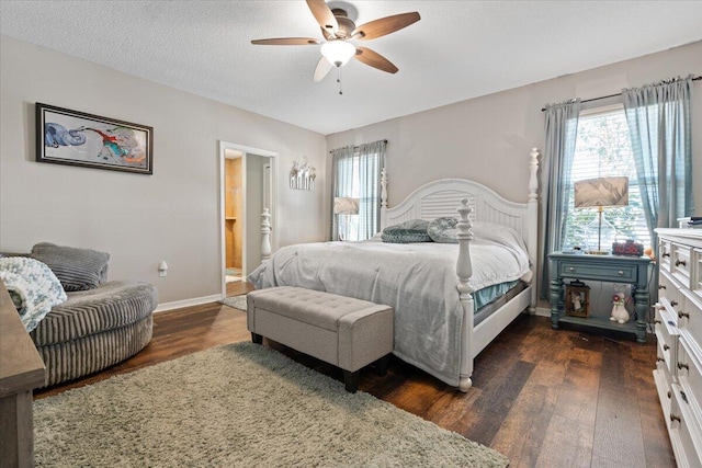 bedroom featuring a textured ceiling, ceiling fan, ensuite bathroom, and dark wood-type flooring