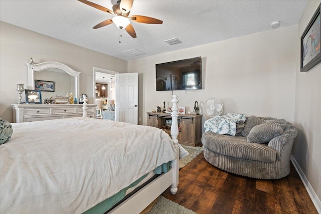 bedroom with a textured ceiling, ceiling fan, and dark hardwood / wood-style floors