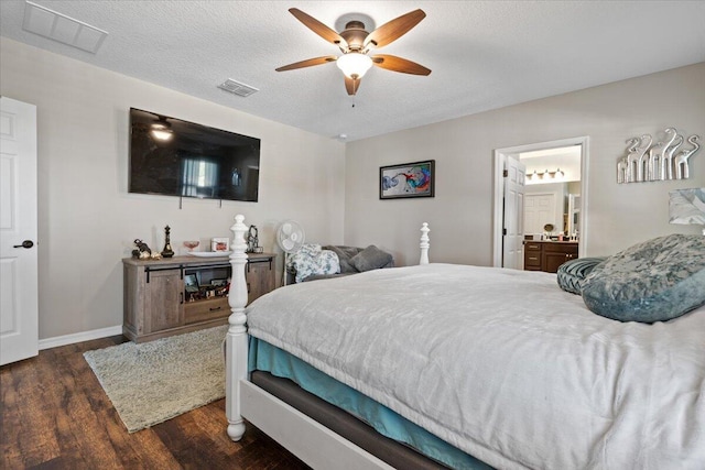 bedroom with a textured ceiling, dark hardwood / wood-style flooring, ensuite bath, and ceiling fan