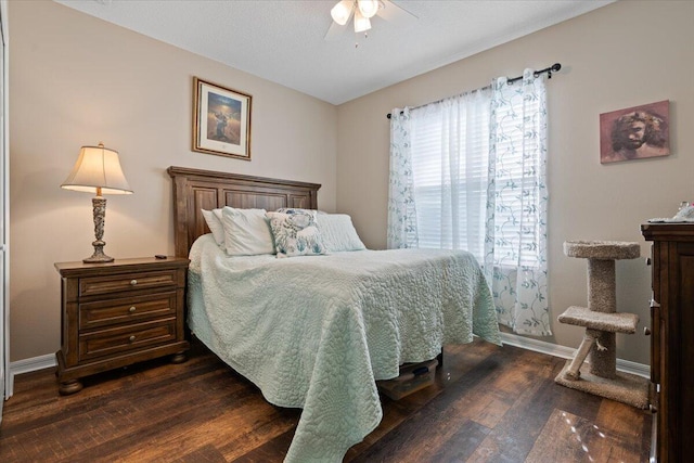 bedroom with multiple windows, dark hardwood / wood-style flooring, and ceiling fan