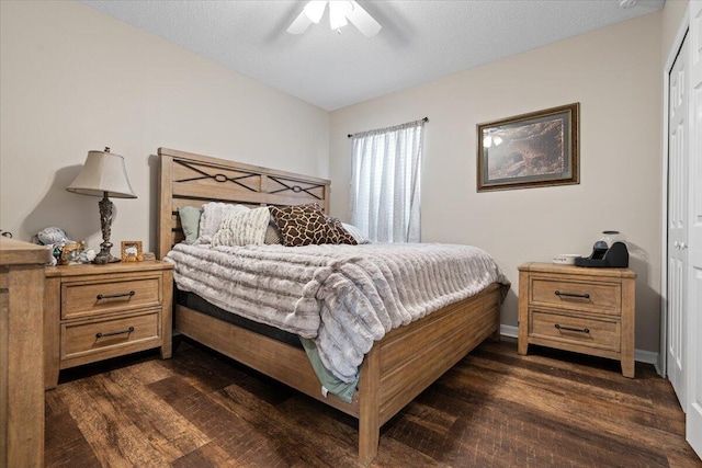 bedroom with a textured ceiling, ceiling fan, a closet, and dark hardwood / wood-style floors