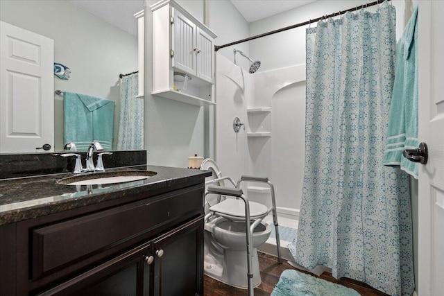 bathroom featuring toilet, vanity, and hardwood / wood-style flooring