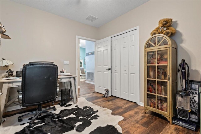 office featuring dark hardwood / wood-style flooring and a textured ceiling