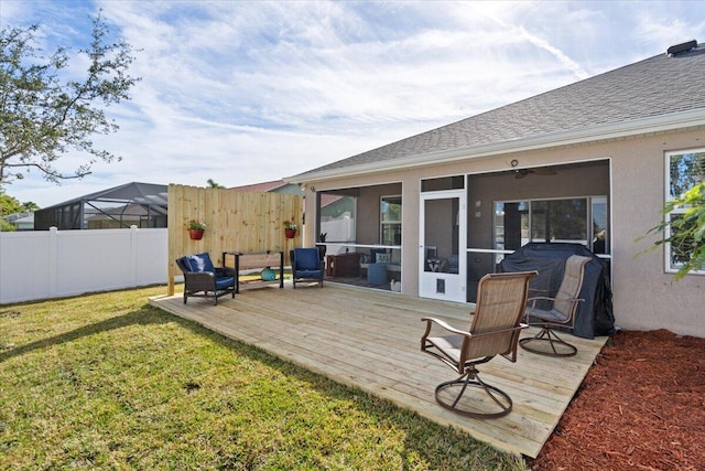 exterior space with a deck, a lawn, and a sunroom