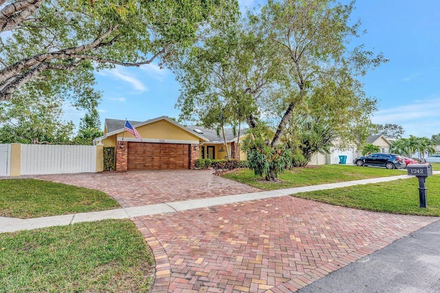 view of front of home with a garage and a front yard