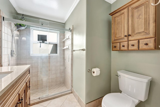 bathroom with tile patterned floors, toilet, a shower with door, vanity, and ornamental molding