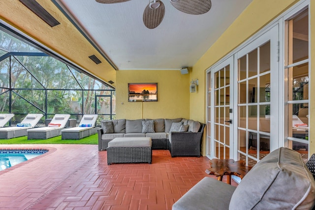 sunroom featuring ceiling fan