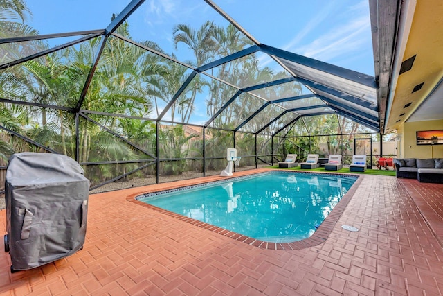 view of swimming pool with an outdoor living space, a patio, area for grilling, and a lanai