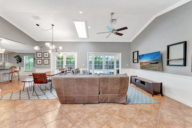 living room with a textured ceiling, ceiling fan, french doors, and lofted ceiling