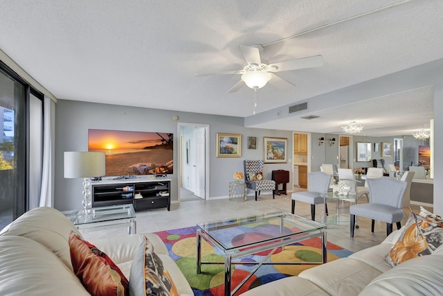 tiled living room featuring ceiling fan and a textured ceiling