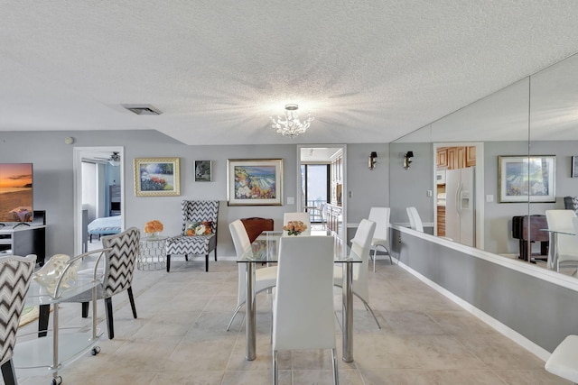 dining area with a notable chandelier and a textured ceiling