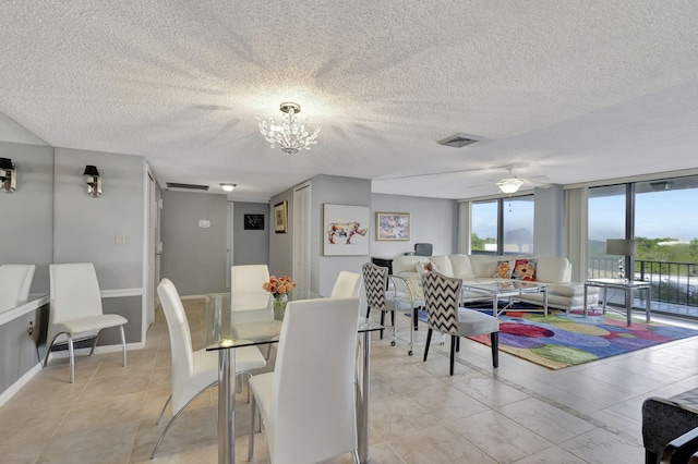 dining space featuring floor to ceiling windows, ceiling fan with notable chandelier, and a textured ceiling