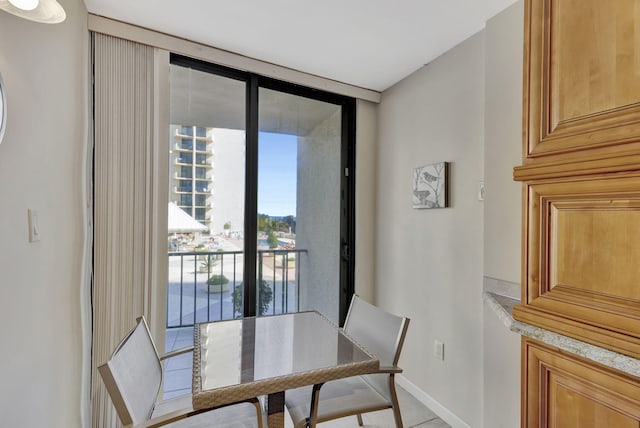 dining space featuring floor to ceiling windows and light tile patterned floors