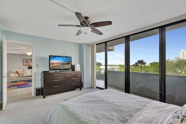 carpeted bedroom featuring access to exterior, ceiling fan, and floor to ceiling windows