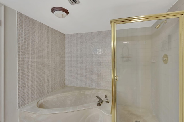 bathroom featuring separate shower and tub