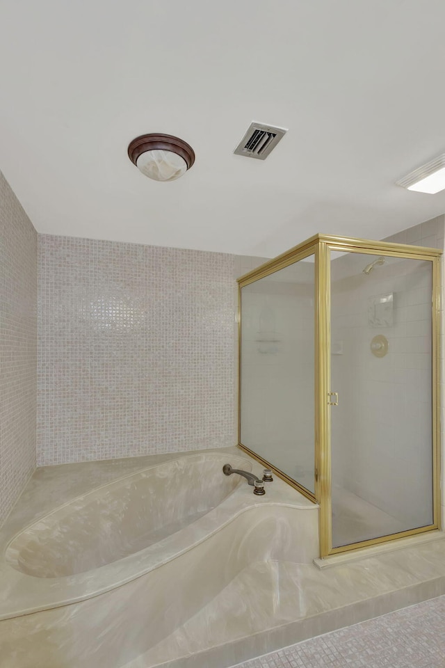 bathroom with separate shower and tub