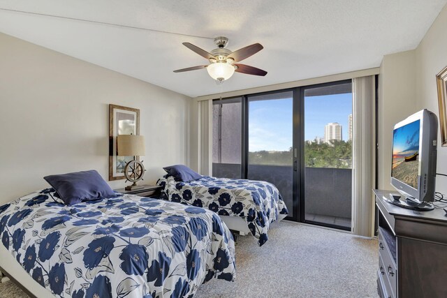 carpeted bedroom with ceiling fan, floor to ceiling windows, and access to exterior