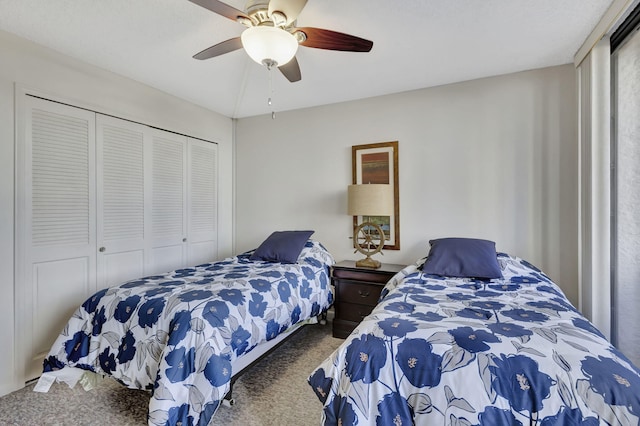 bedroom featuring ceiling fan, a closet, and carpet