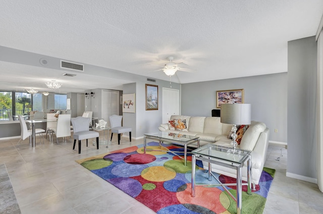 tiled living room featuring a textured ceiling and ceiling fan