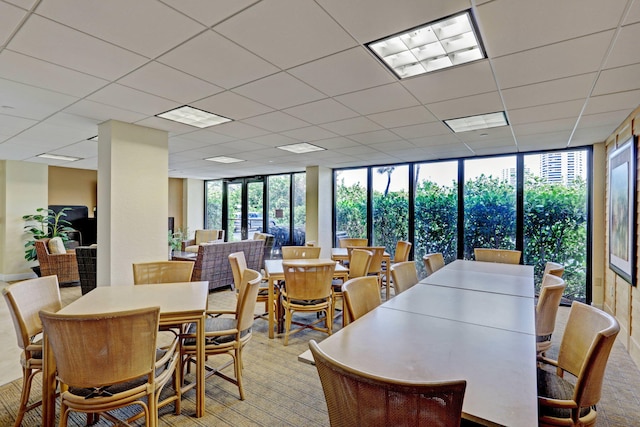 carpeted dining area with floor to ceiling windows