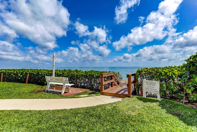 surrounding community featuring a water view and a yard