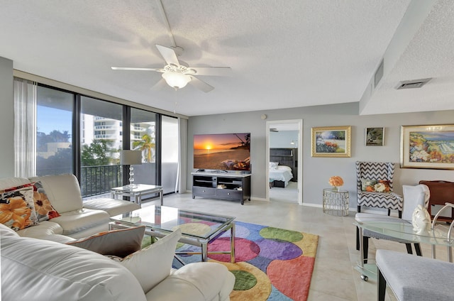 living room featuring floor to ceiling windows, ceiling fan, and a textured ceiling