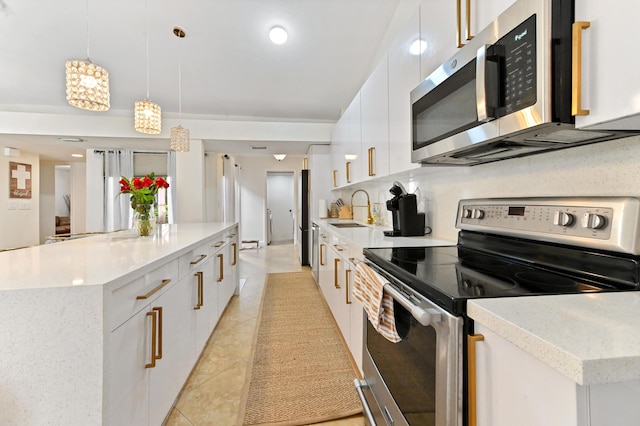 5272 Bolero Cir, Delray Beach, FL 33484 - kitchen featuring appliances with stainless steel finishes, modern cabinets, a center island, white cabinets, and a sink