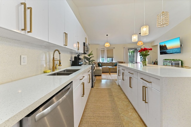 5272 Bolero Cir, Delray Beach, FL 33484 - kitchen with stainless steel appliances, a sink, light tile patterned flooring, white cabinets, and decorative light fixtures