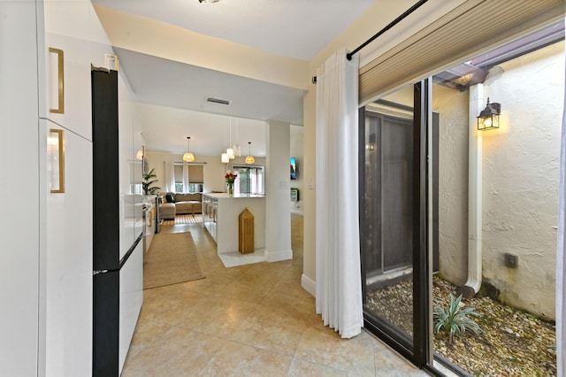 hall featuring light tile patterned floors