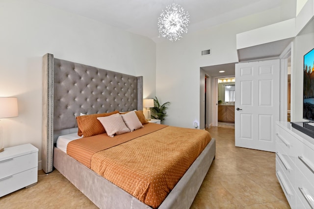 tiled bedroom featuring a chandelier