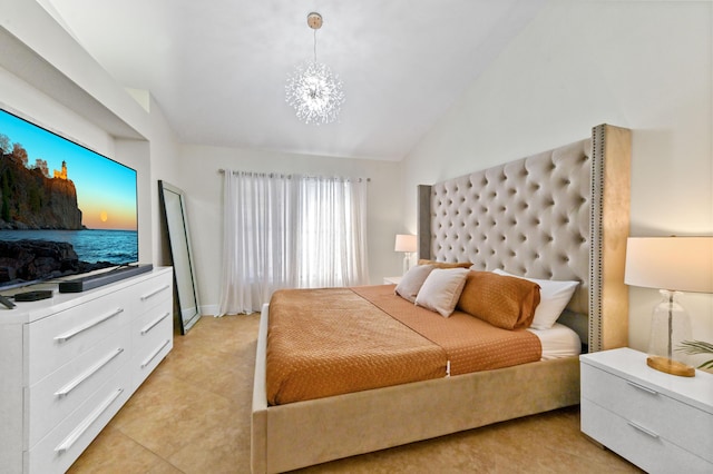 bedroom with lofted ceiling and a notable chandelier