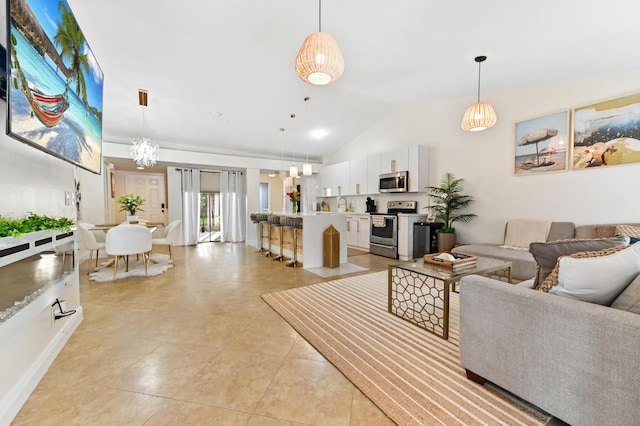 5272 Bolero Cir, Delray Beach, FL 33484 - living area with lofted ceiling, light tile patterned flooring, and a chandelier