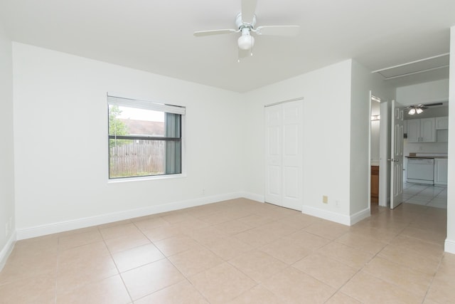 tiled spare room with ceiling fan