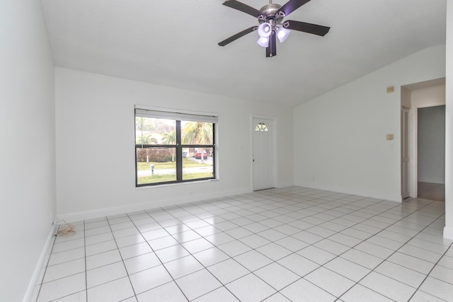 tiled spare room featuring ceiling fan and vaulted ceiling