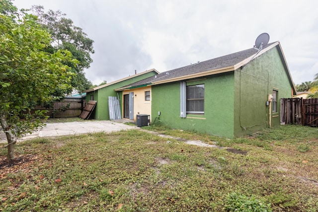 rear view of property with a patio area and central AC unit