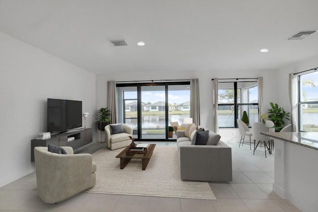 living room featuring plenty of natural light and light tile patterned floors