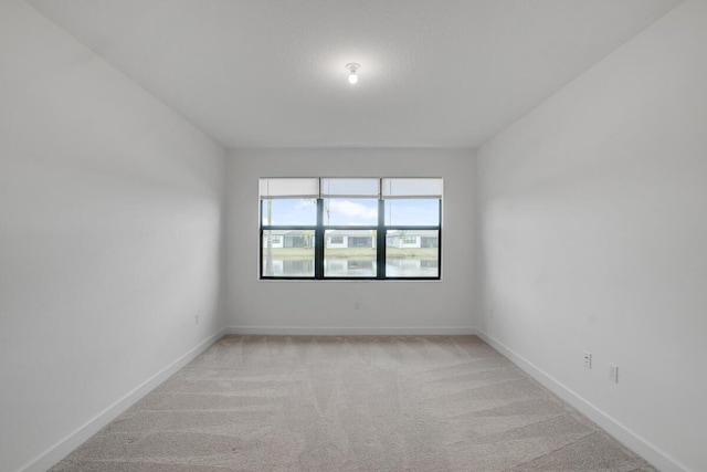 unfurnished room with light carpet