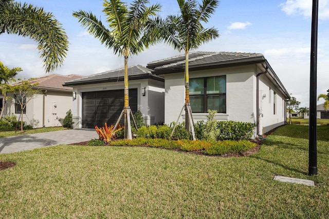 12535 SW Blue Mangrove Pkwy, Port Saint Lucie, FL 34987 - prairie-style house with stucco siding, an attached garage, driveway, and a front yard