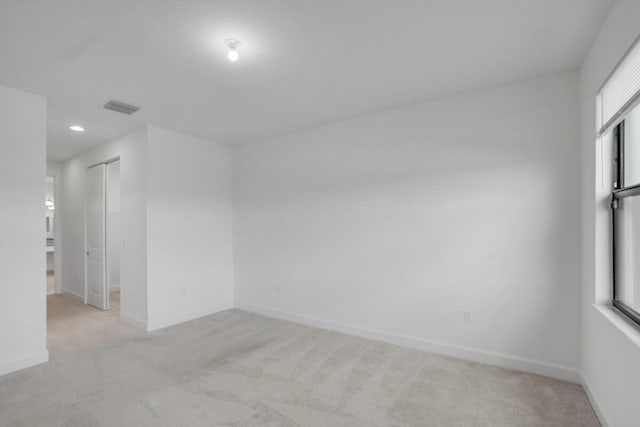 unfurnished room with light carpet and a healthy amount of sunlight