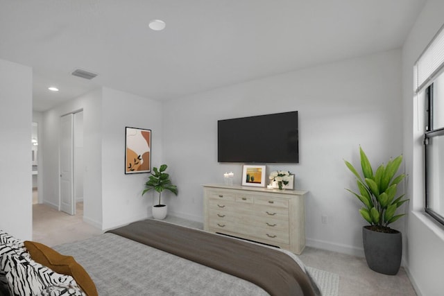 carpeted bedroom with multiple windows and a closet