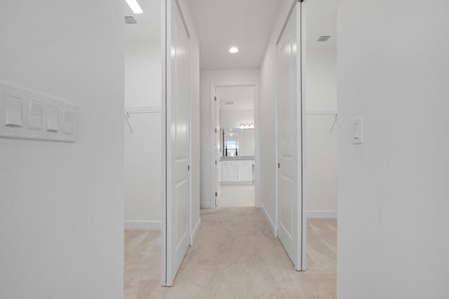 12535 SW Blue Mangrove Pkwy, Port Saint Lucie, FL 34987 - hallway with light colored carpet, baseboards, and recessed lighting