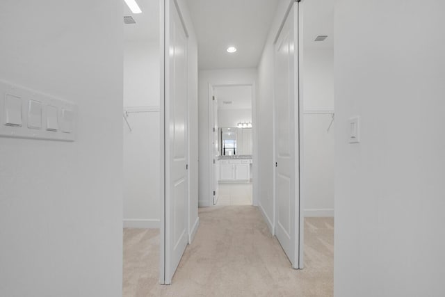 corridor with light colored carpet