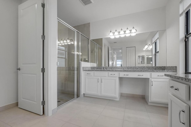 12535 SW Blue Mangrove Pkwy, Port Saint Lucie, FL 34987 - full bath with a shower stall, tile patterned floors, vanity, and baseboards